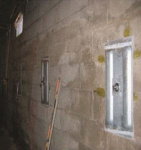 photo closeup of the wall plate of the Hold-Right Anchor System installed in a basement